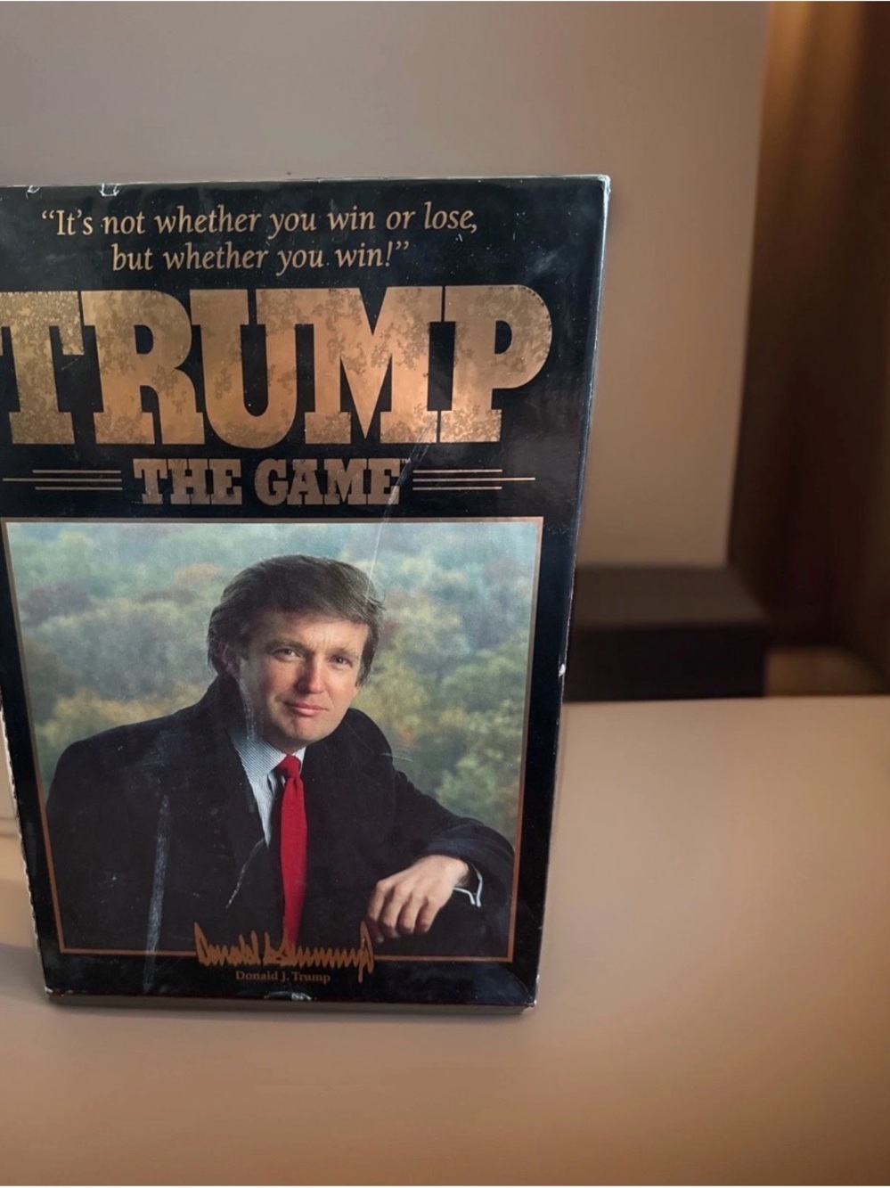 Trump The Game - Black and Gold Strategy Box with Red Accent